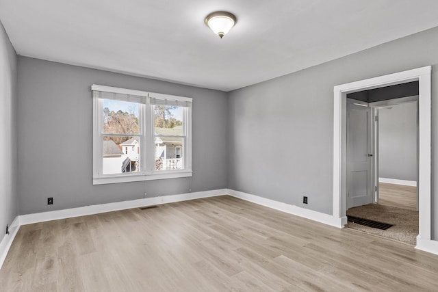 empty room with light hardwood / wood-style flooring