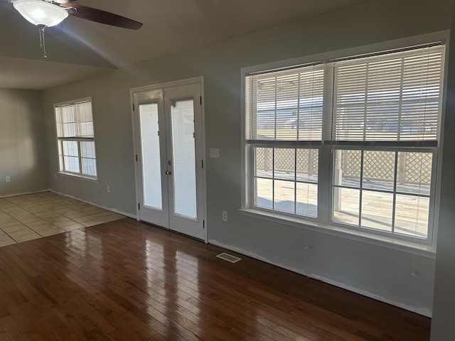 interior space with hardwood / wood-style flooring, ceiling fan, vaulted ceiling, and french doors