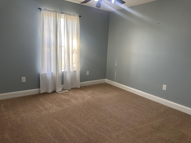 empty room with ceiling fan and carpet floors