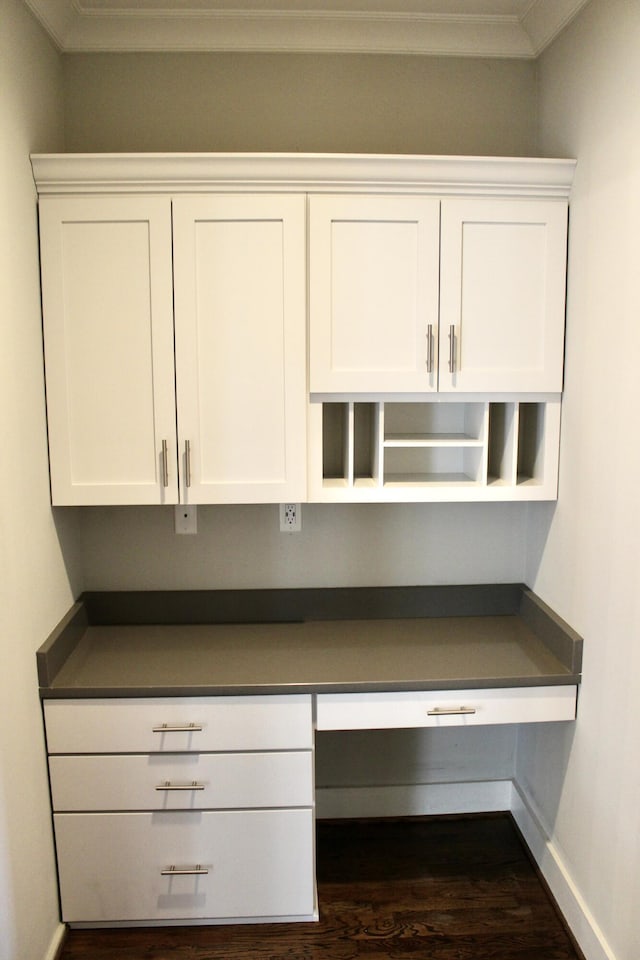 details with hardwood / wood-style floors, crown molding, and built in desk