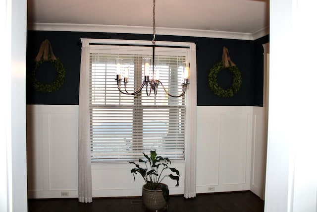 dining space featuring an inviting chandelier, crown molding, dark hardwood / wood-style flooring, and a healthy amount of sunlight