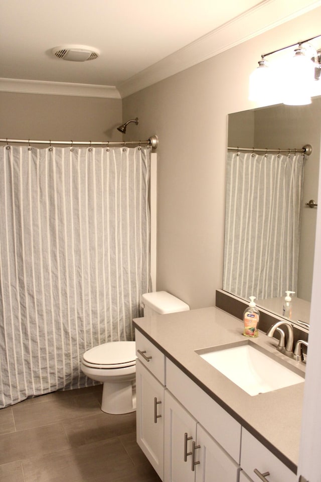 bathroom featuring vanity, ornamental molding, toilet, and walk in shower