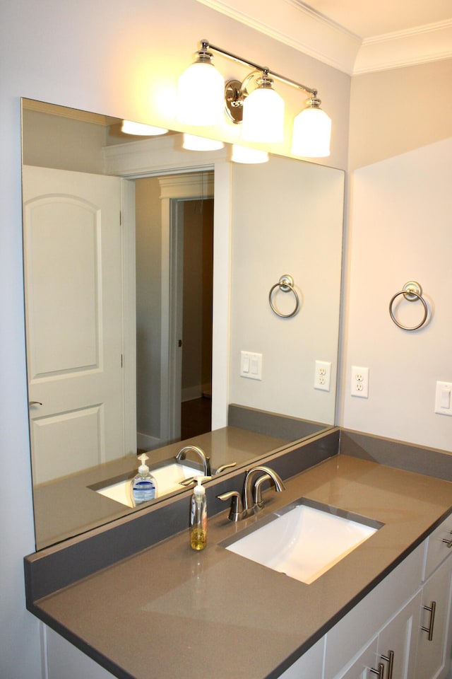 bathroom featuring crown molding and vanity