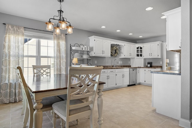 kitchen featuring sink, a notable chandelier, white cabinetry, hanging light fixtures, and light tile patterned flooring