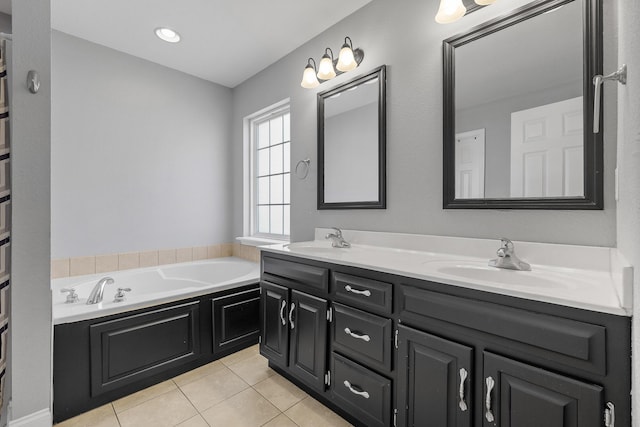 bathroom featuring tile patterned flooring, vanity, and a bath