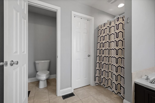 bathroom with toilet, tile patterned floors, and plus walk in shower