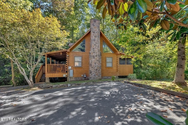 view of side of home featuring a wooden deck