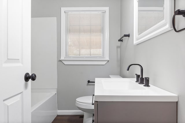 bathroom featuring vanity, hardwood / wood-style flooring, and toilet