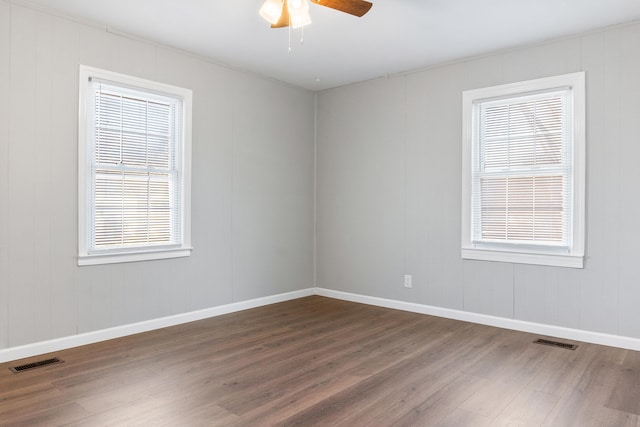 spare room featuring hardwood / wood-style floors and ceiling fan