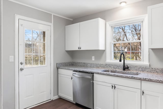 kitchen featuring a wealth of natural light, white cabinetry, sink, light stone counters, and stainless steel dishwasher