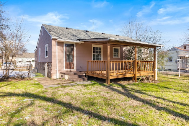 back of house with a yard and a wooden deck