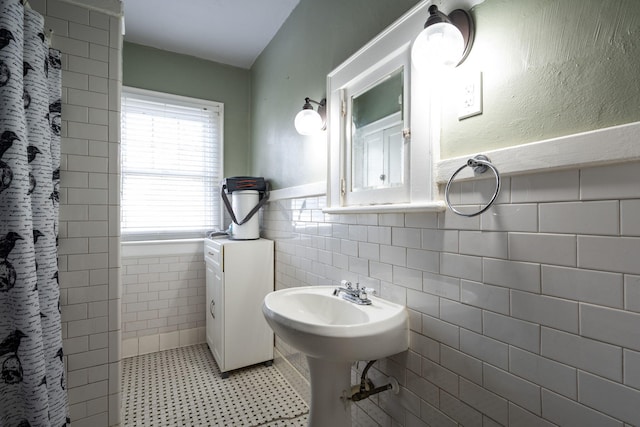 bathroom featuring tile patterned flooring, tile walls, and walk in shower