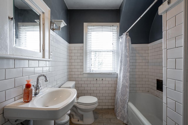 full bathroom featuring tile patterned floors, sink, tile walls, and toilet