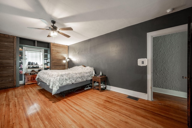 bedroom with ceiling fan and wood-type flooring