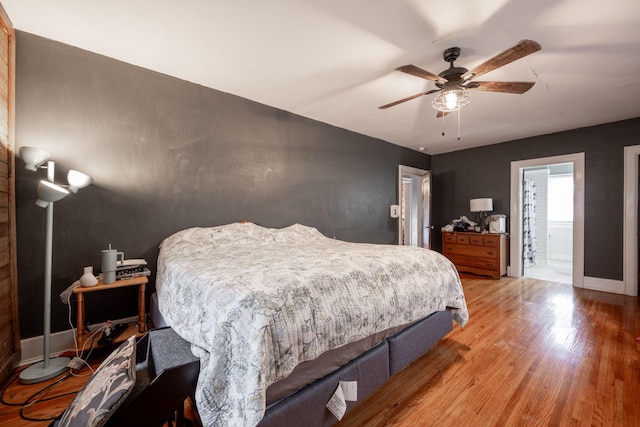 bedroom featuring ceiling fan, hardwood / wood-style floors, and ensuite bathroom