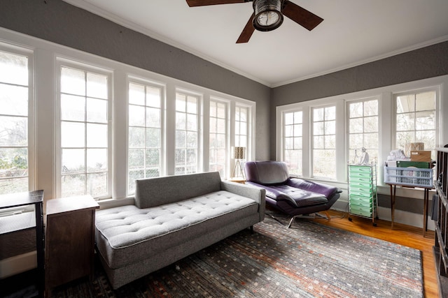 sunroom / solarium featuring ceiling fan