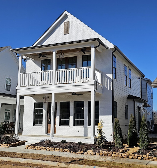 view of front of house featuring ceiling fan, a balcony, and covered porch