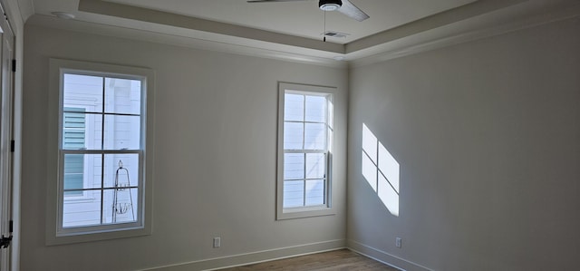 empty room with wood-type flooring, plenty of natural light, and ceiling fan