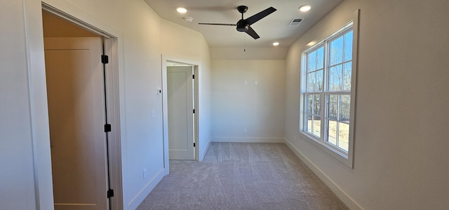 spare room with ceiling fan, lofted ceiling, and light carpet