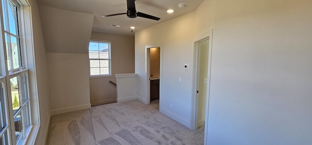 corridor featuring light colored carpet