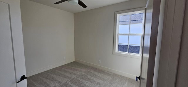 spare room featuring ceiling fan and carpet