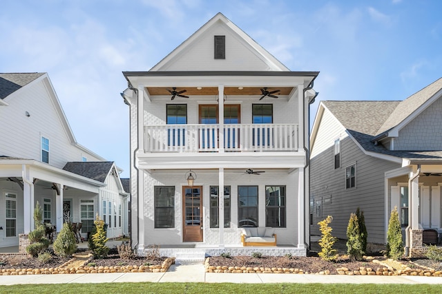 view of front of property with a porch, a balcony, and a ceiling fan