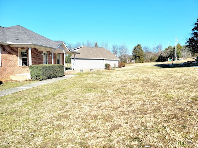 view of side of property with a yard