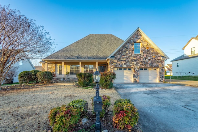 view of front of property featuring a porch and a garage