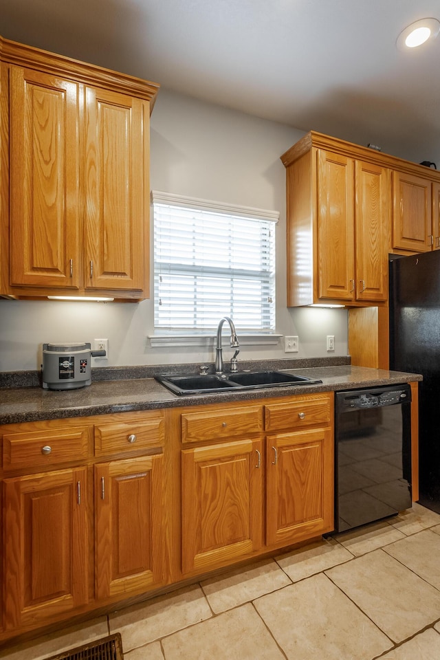 kitchen with light tile patterned floors, sink, and black appliances