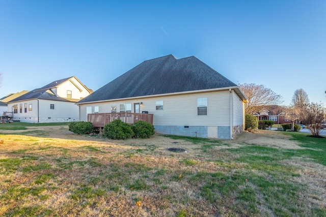 view of side of home with a yard and a wooden deck