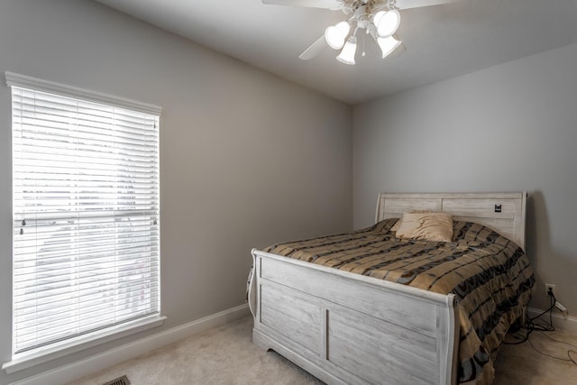 bedroom with light carpet and ceiling fan