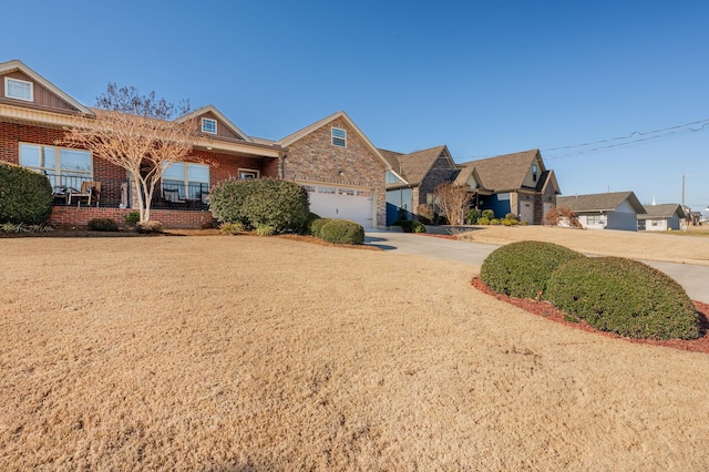 view of front of property with a garage, concrete driveway, brick siding, and covered porch