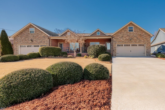 view of front facade featuring a porch, driveway, and an attached garage