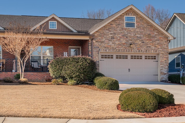 view of front of house with a garage, concrete driveway, stone siding, a porch, and board and batten siding