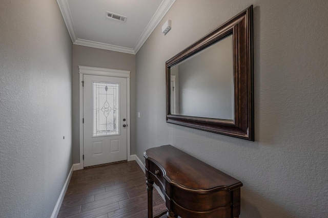 doorway with a textured wall, visible vents, baseboards, dark wood finished floors, and crown molding