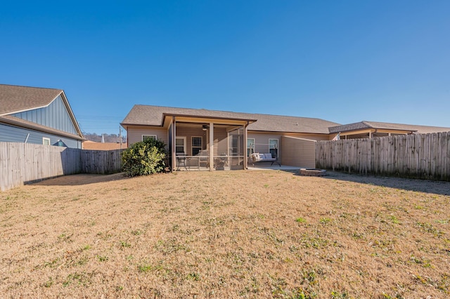 back of house with a yard, a patio, a fenced backyard, and a sunroom