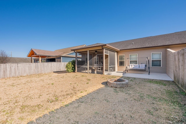 rear view of property with a fire pit, a ceiling fan, a sunroom, fence, and a patio area