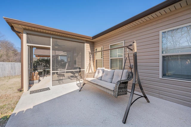 view of patio / terrace with a sunroom, fence, and an outdoor hangout area