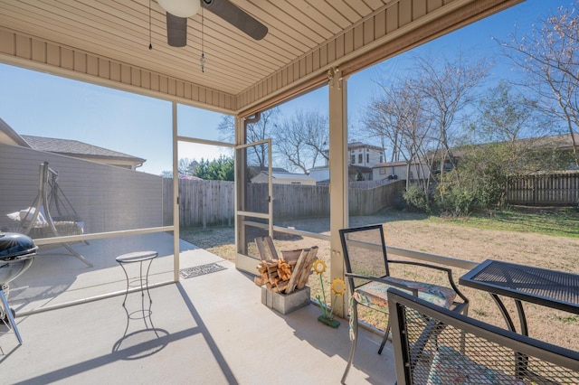 sunroom / solarium featuring ceiling fan