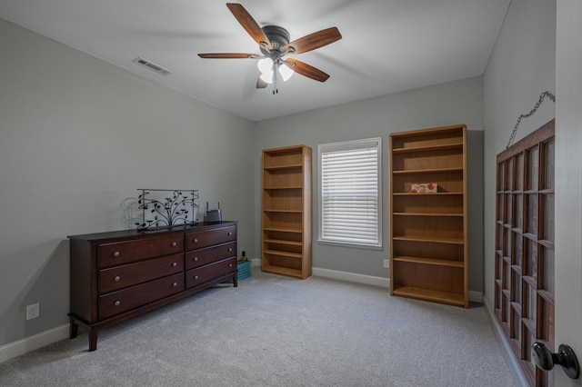 interior space with ceiling fan, carpet floors, visible vents, and baseboards