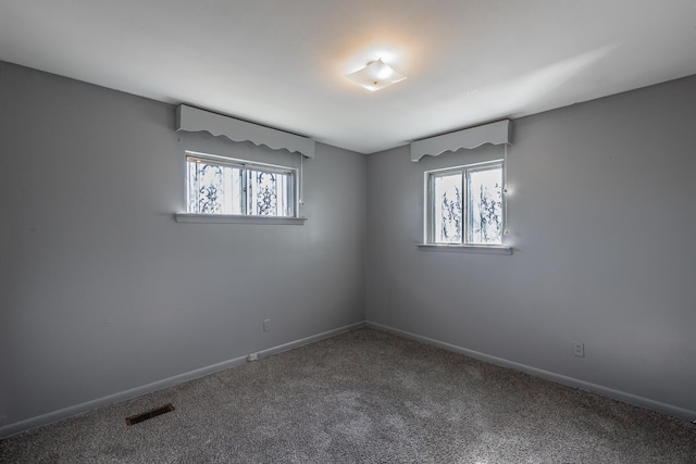 carpeted empty room with a wealth of natural light