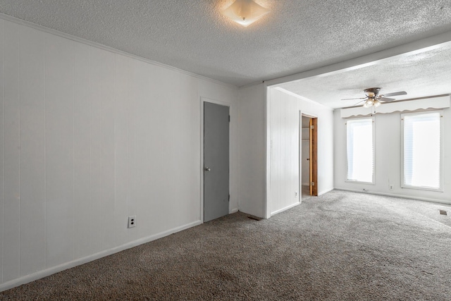 spare room with carpet, ceiling fan, ornamental molding, and a textured ceiling