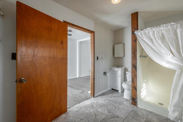 bathroom with toilet, vanity, and walk in shower