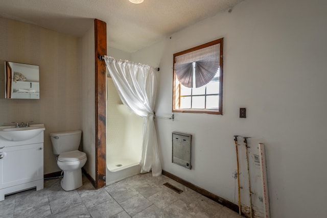 bathroom featuring toilet, vanity, heating unit, a textured ceiling, and a shower with shower curtain