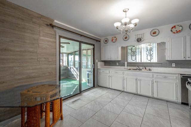 kitchen with decorative backsplash, sink, and white cabinetry