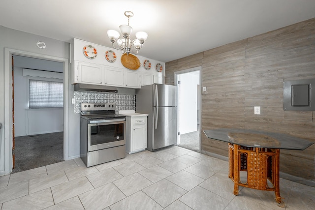 kitchen featuring an inviting chandelier, white cabinetry, stainless steel appliances, light colored carpet, and electric panel