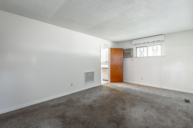 spare room with a textured ceiling and carpet