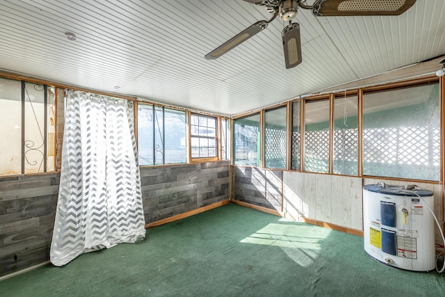 unfurnished sunroom featuring water heater and ceiling fan