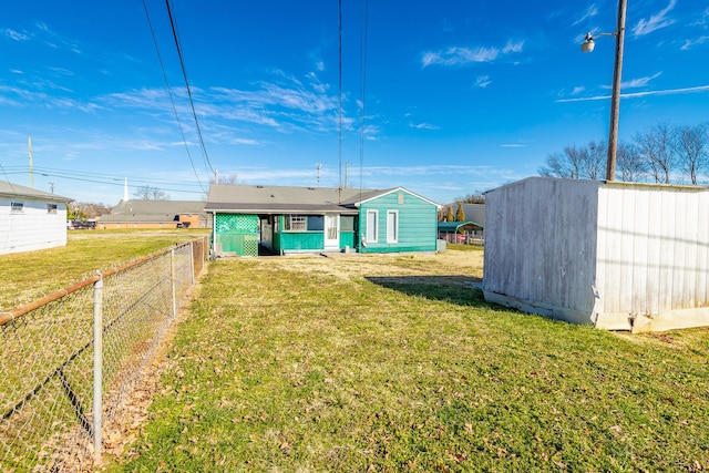 rear view of property with a yard