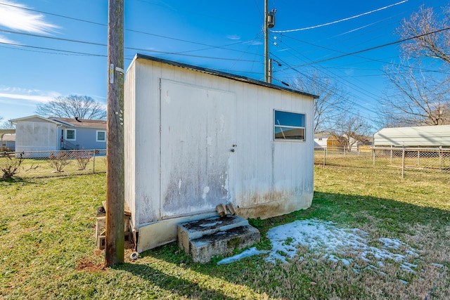 view of outdoor structure featuring a lawn